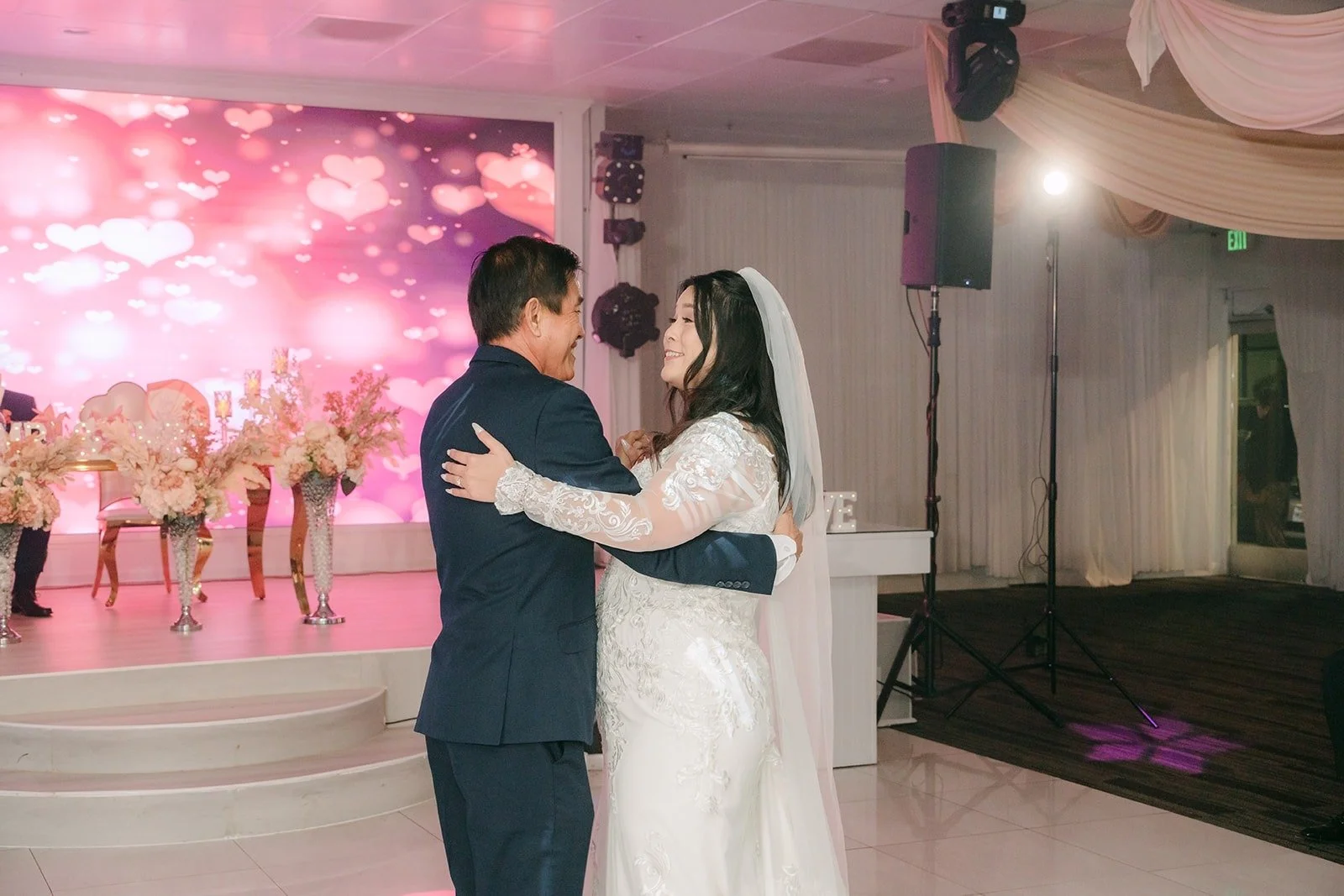 Amy sharing a parent dance in front of the pink glowing screen