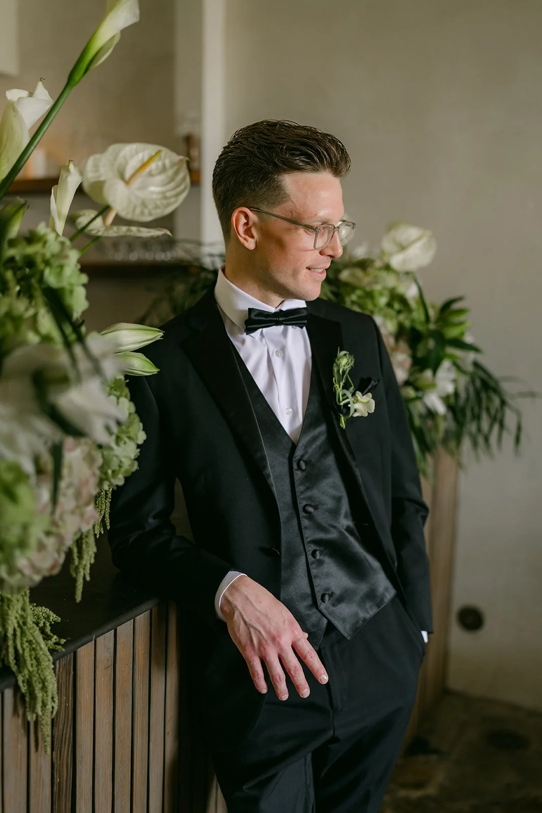 Matthew looking down in his tuxedo