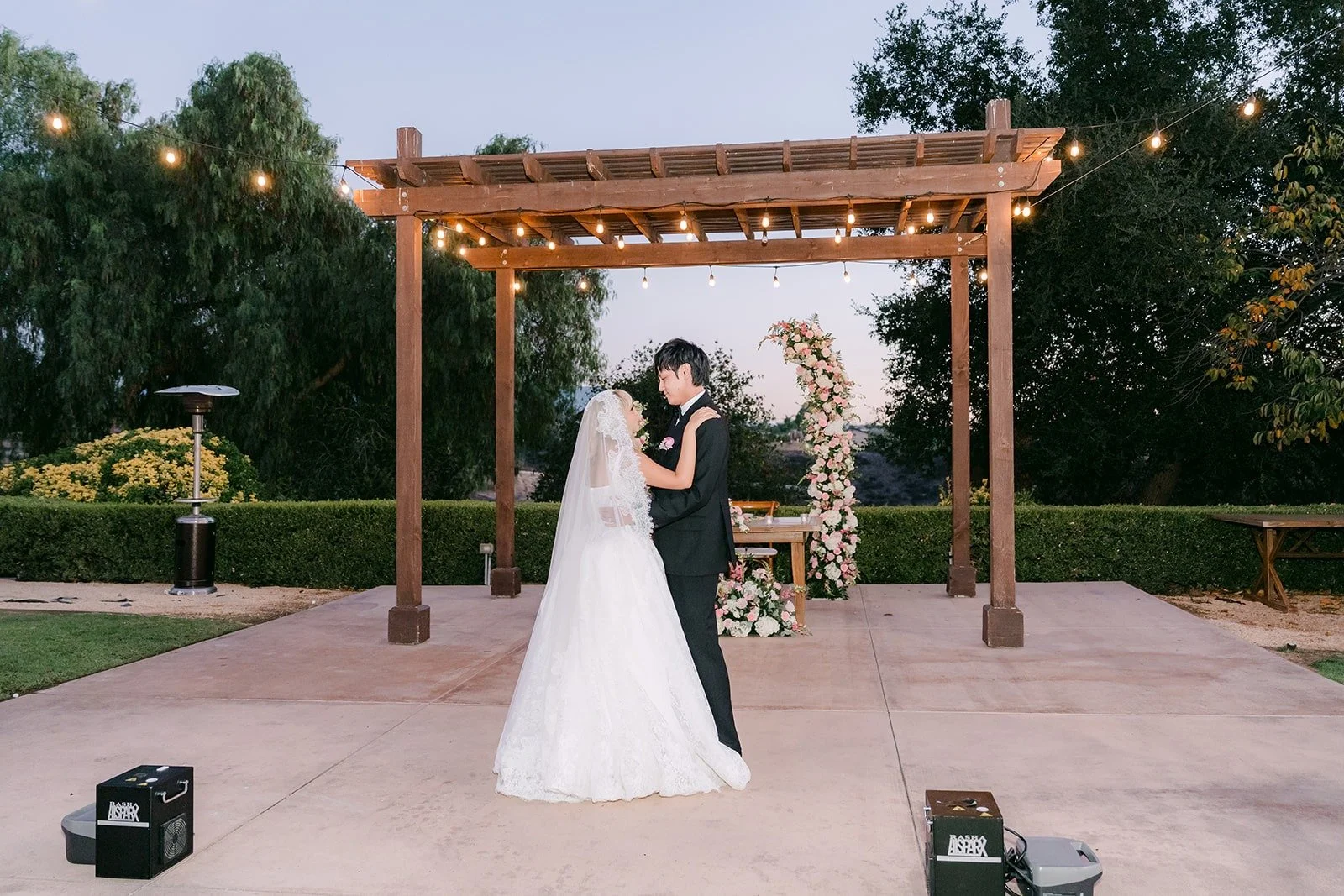 Wide view of the first dance on the patio at night