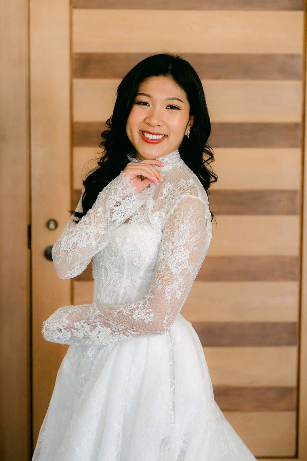 Kim smiling in her lace gown before the ceremony