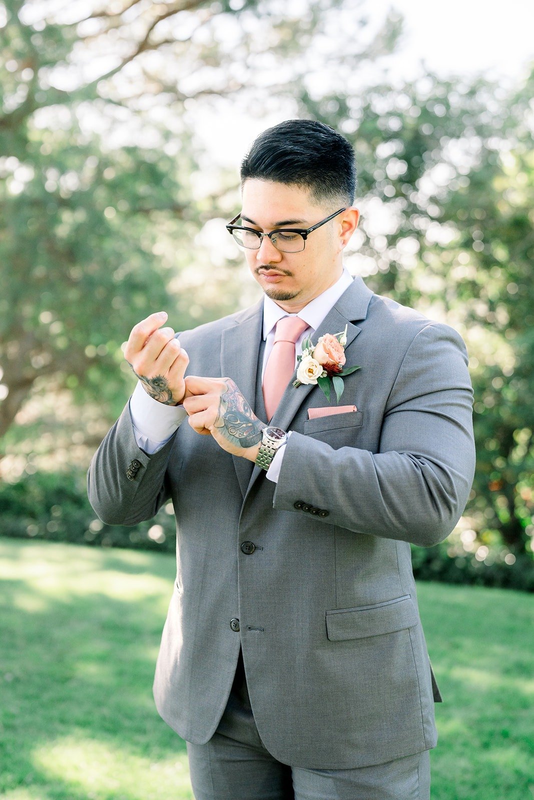Mikey adjusts his cufflinks