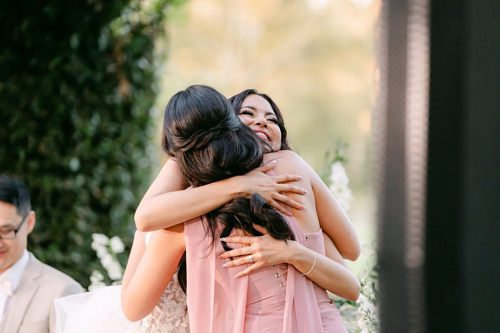 Sandra hugging her maid of honor after the toast.