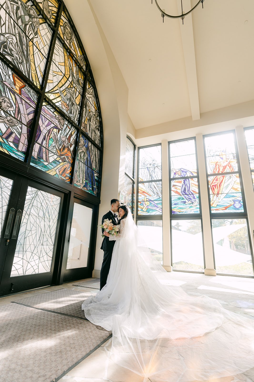 Kim posing under the stained glass at the church entrance