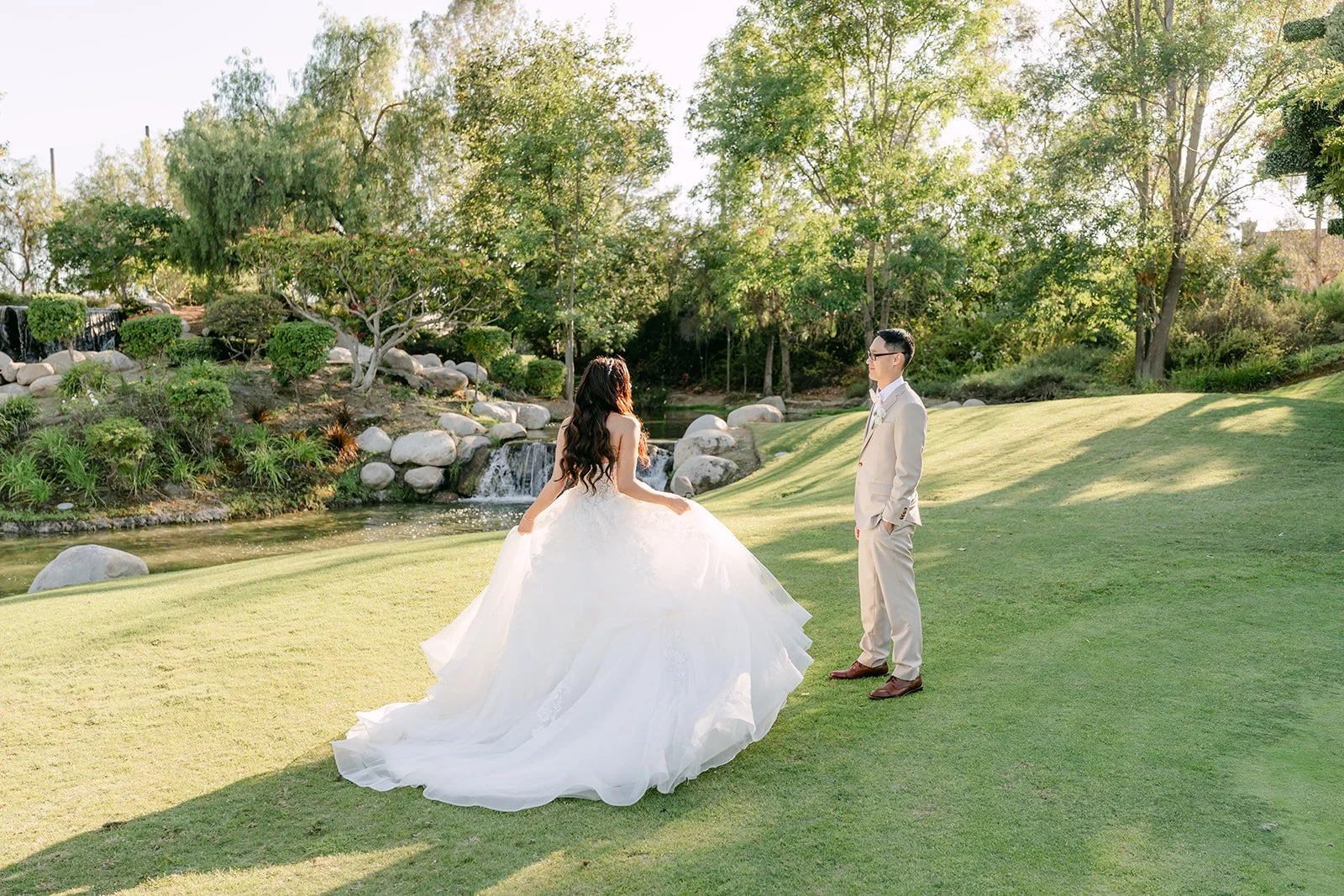 Sandra and Kevin on the open lawn among the trees, photographed by One and Only Production.