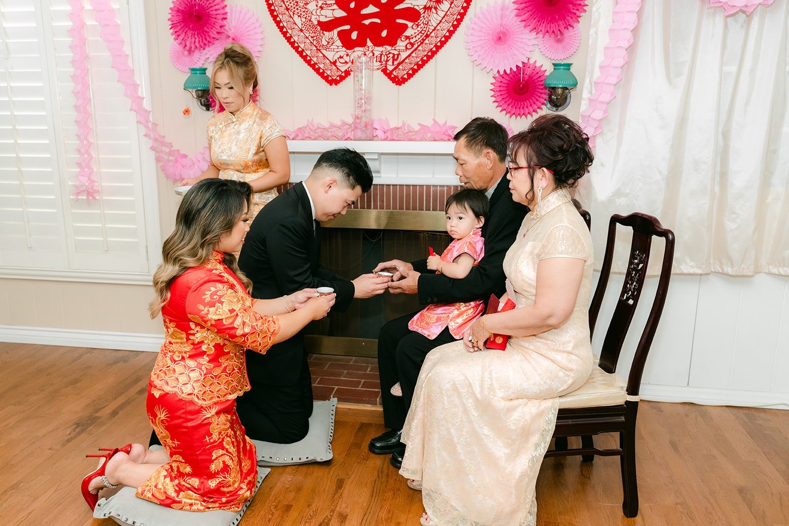 Candice and Vincent serving tea to family