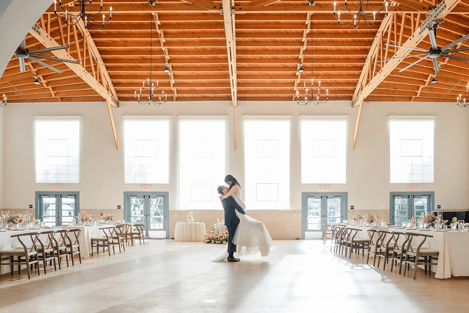 Wide view of the first dance under the timber trusses