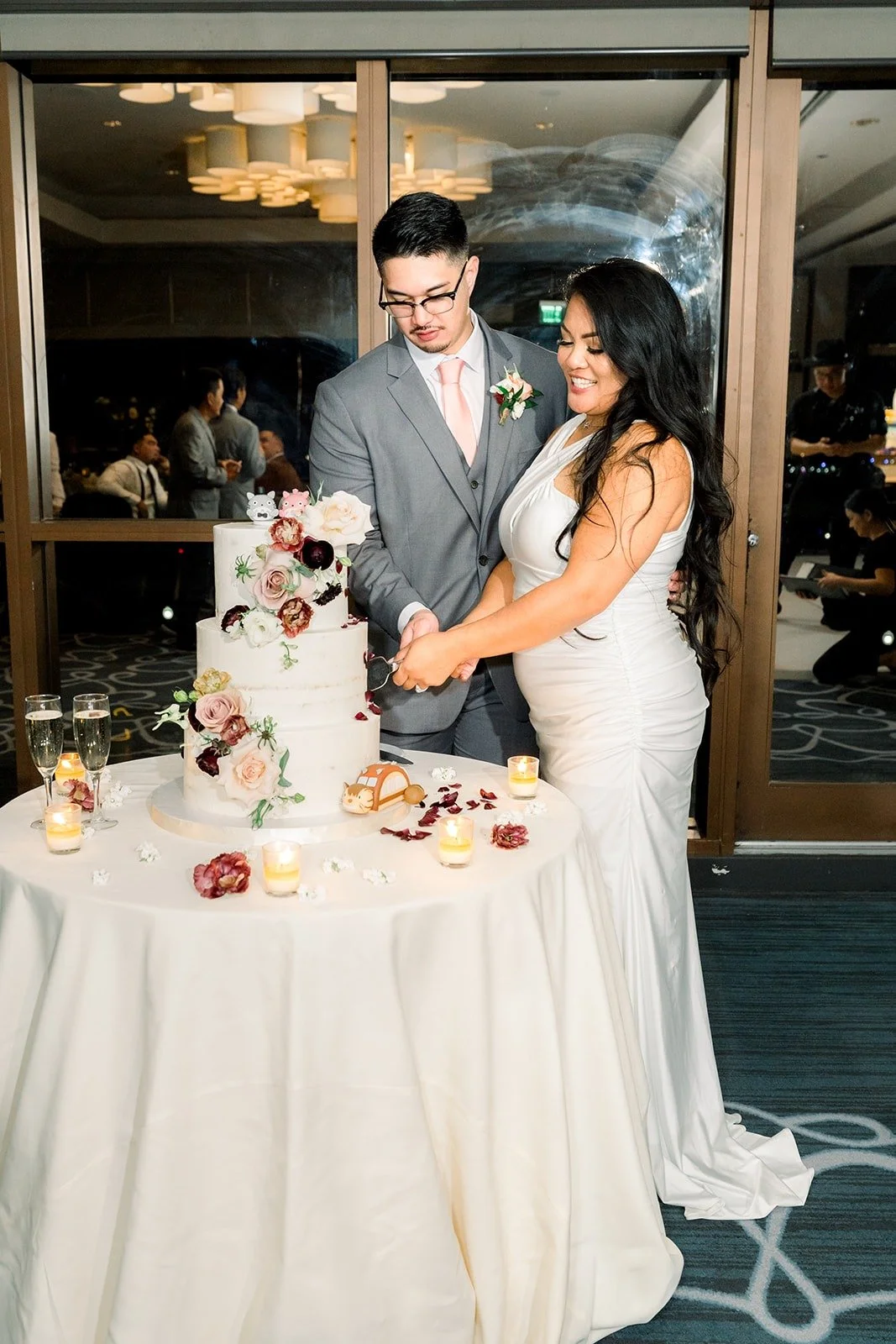 Betsy and Mikey cut the cake together