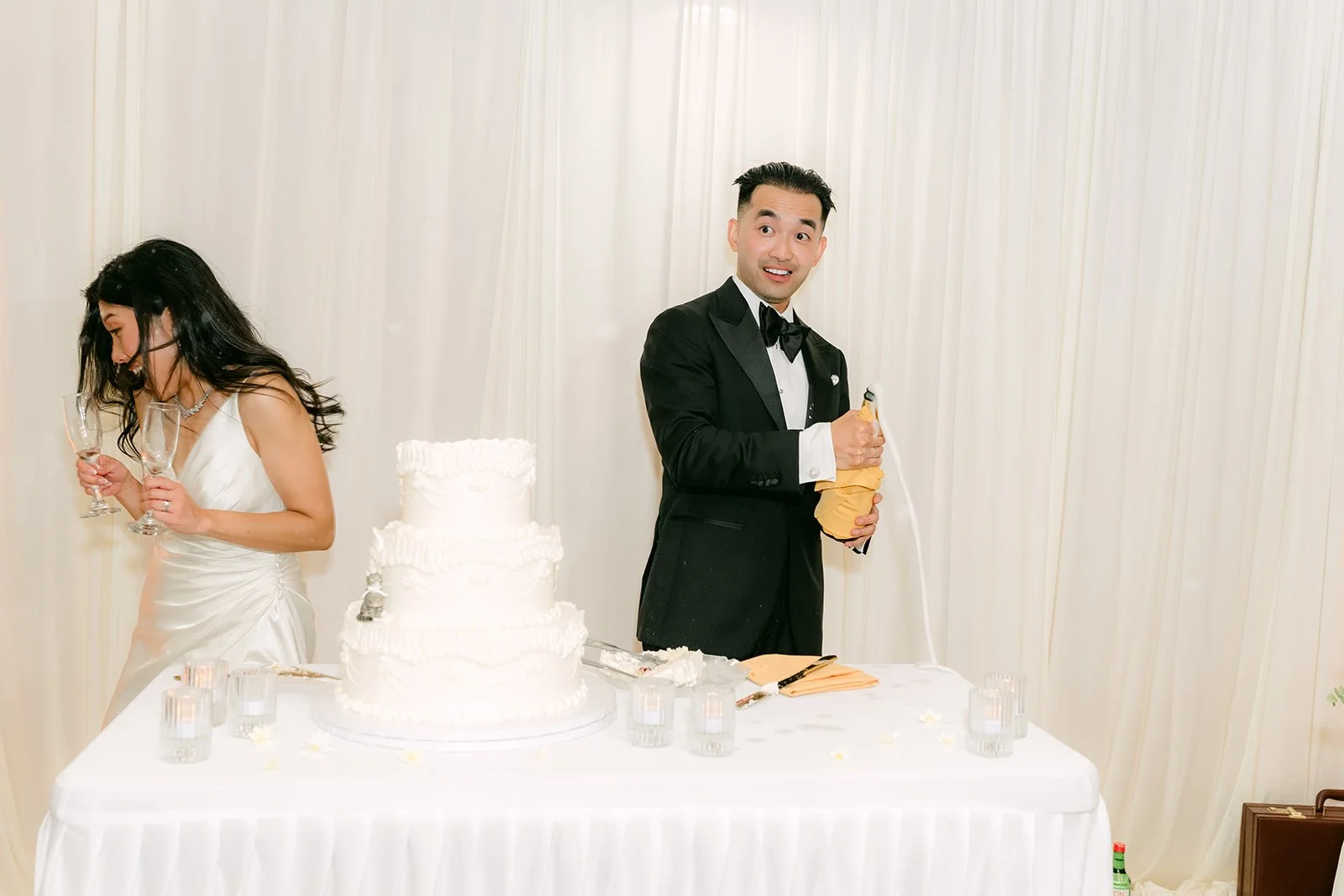 Kim and Vincent laughing at the cake cutting