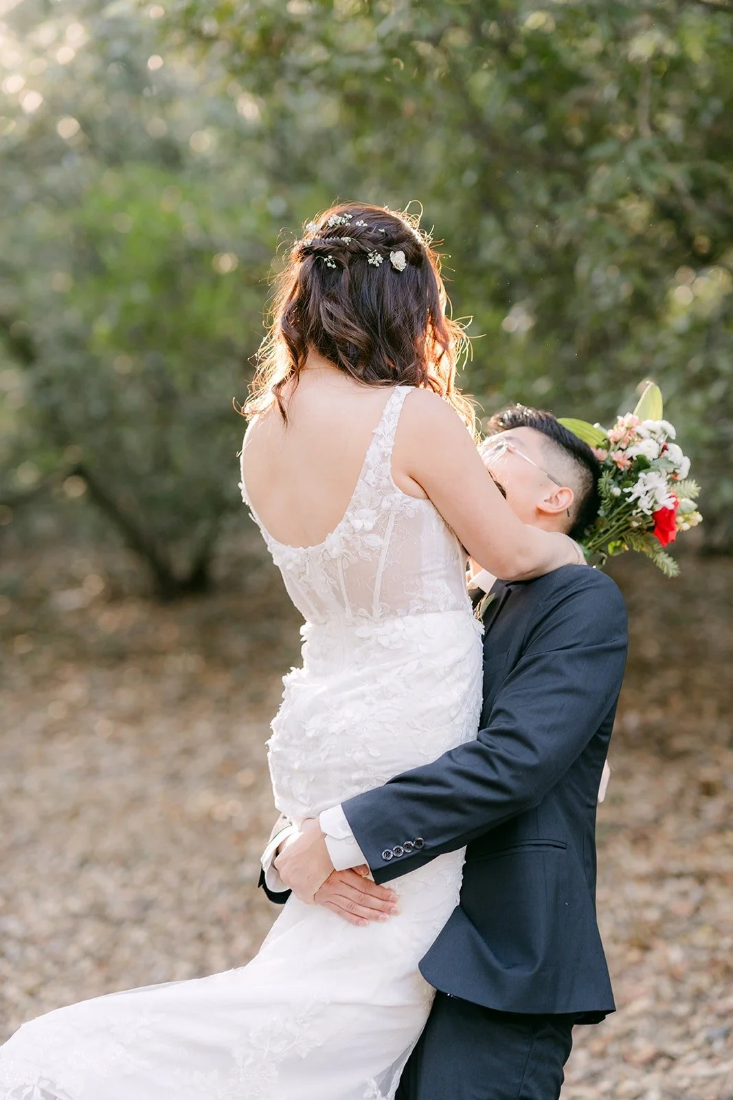 Robert lifts Shayna into a hug on the trail