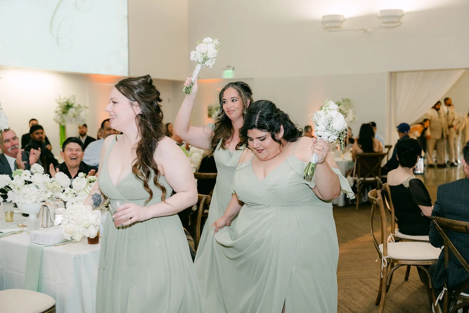The bridesmaids dancing in during the grand entrance.