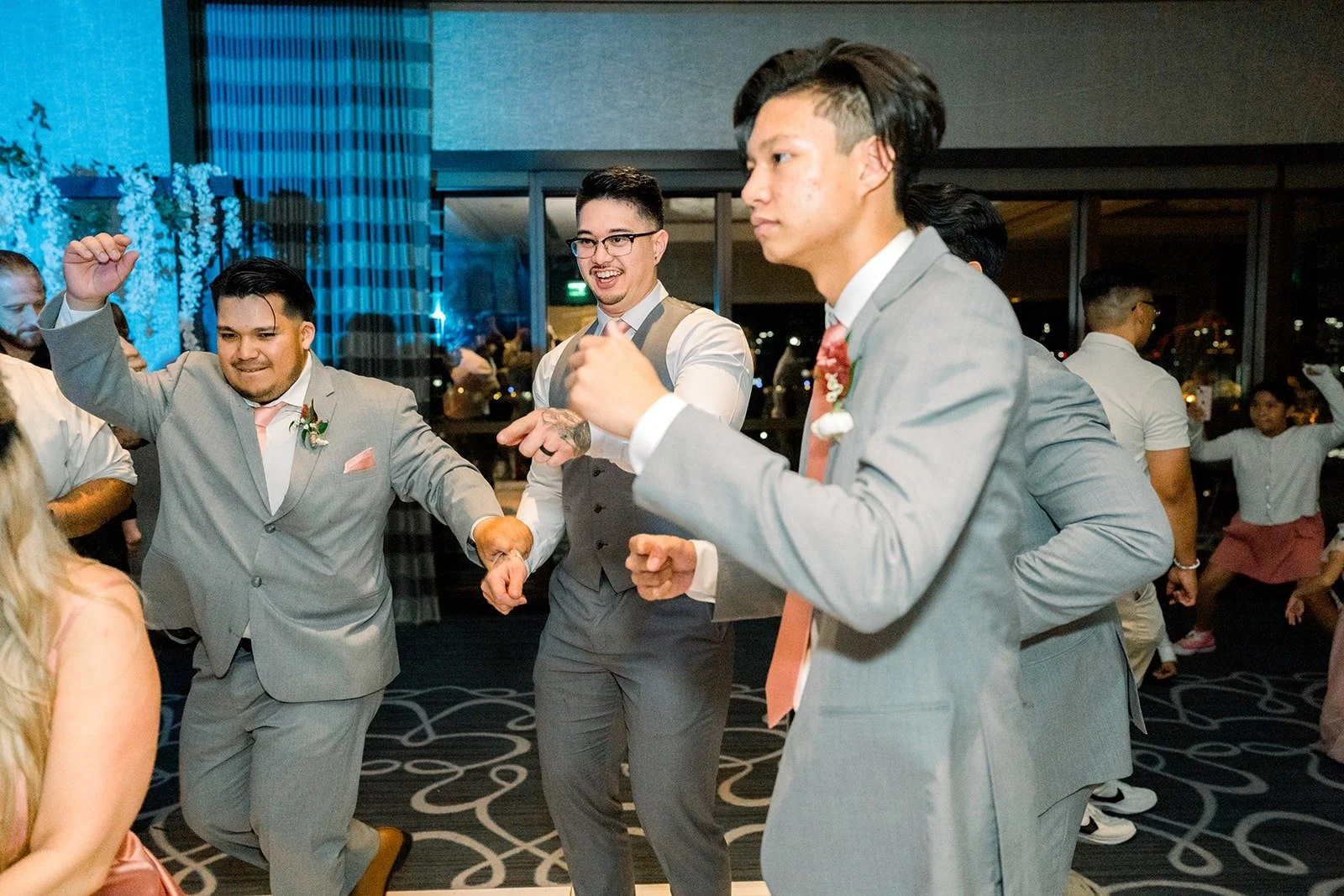 Mikey dances with friends under the chandeliers