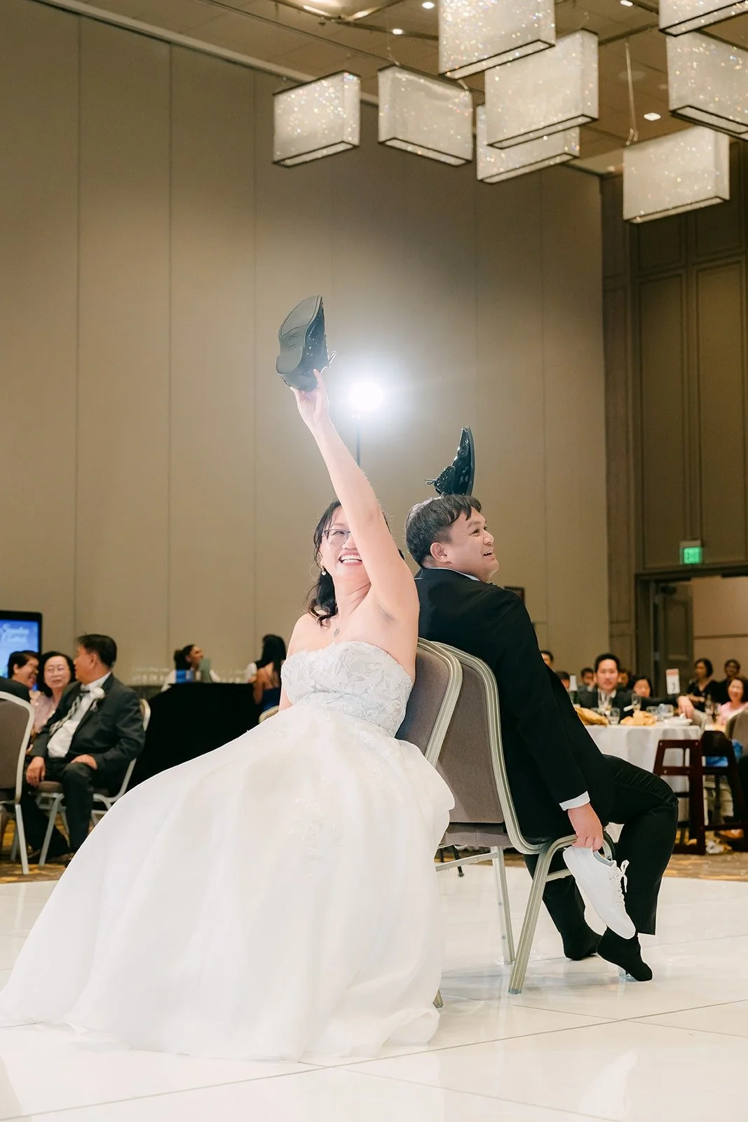 Stella holding up a shoe to answer a question during the shoe game
