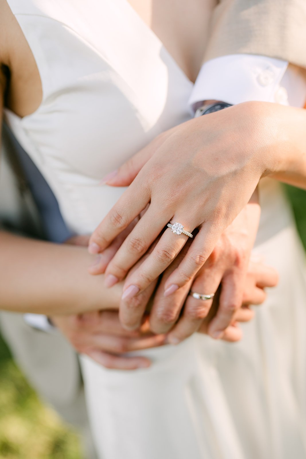 Close-up of Kim and Vincent's hands with her engagement ring.