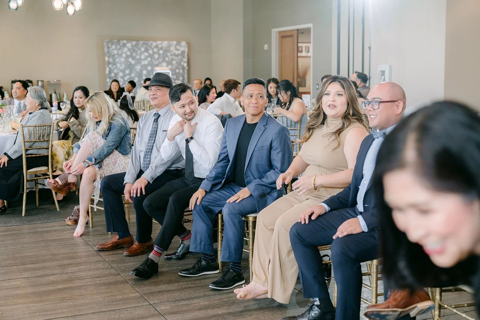 Guests laughing in their seats during the Find It game
