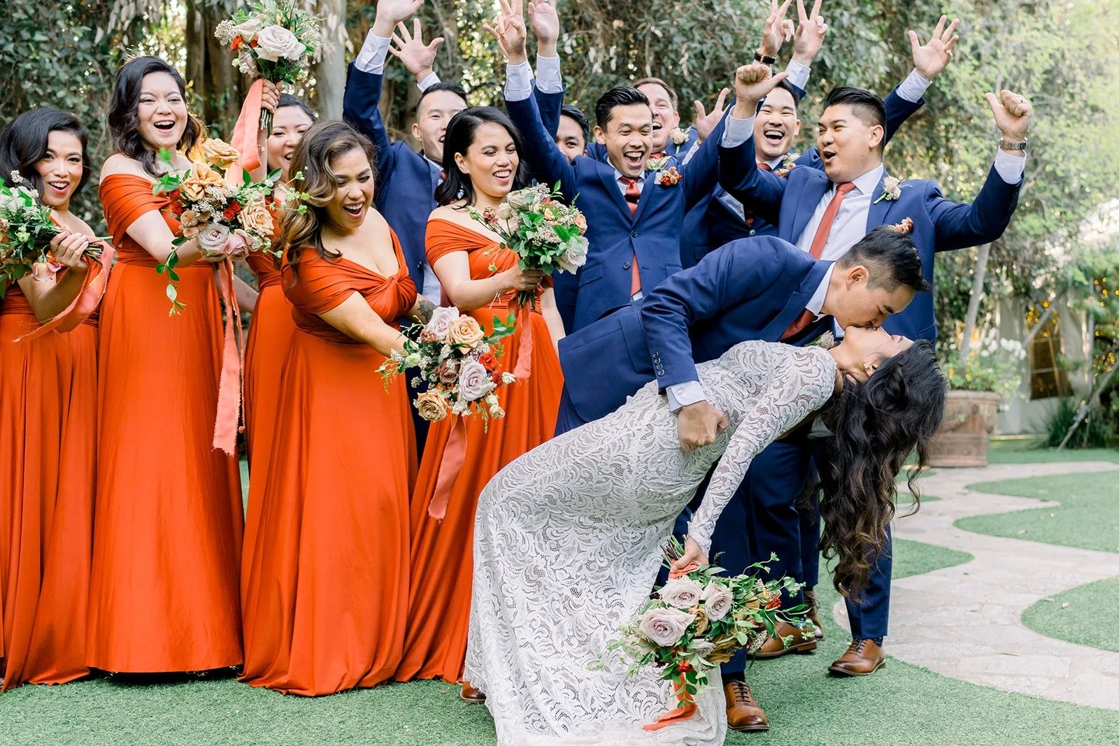 The wedding party celebrating around Hannah and Vincent, photographed by One and Only Production