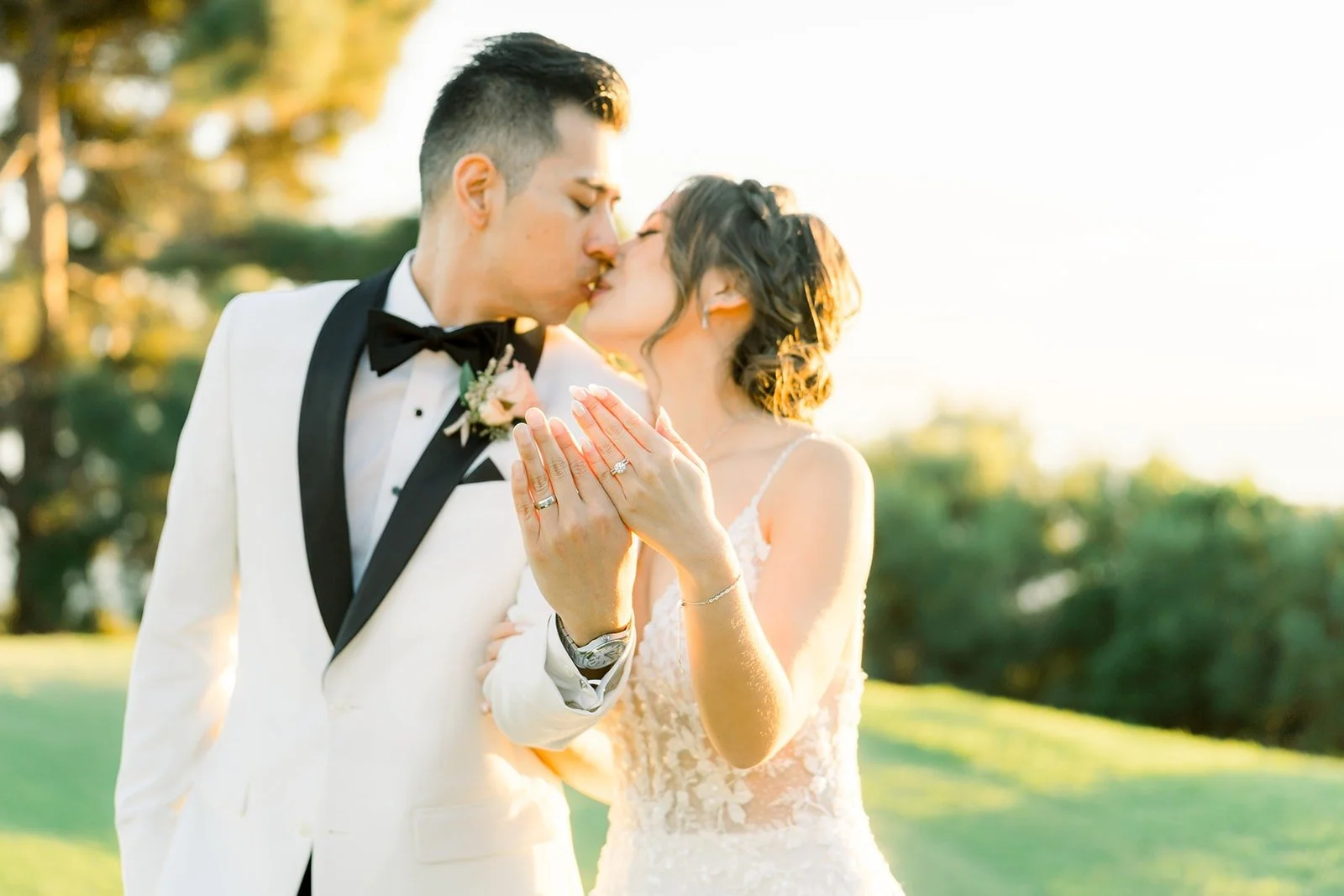 Josephine and David sharing a kiss in the golden light, photographed by One and Only Production