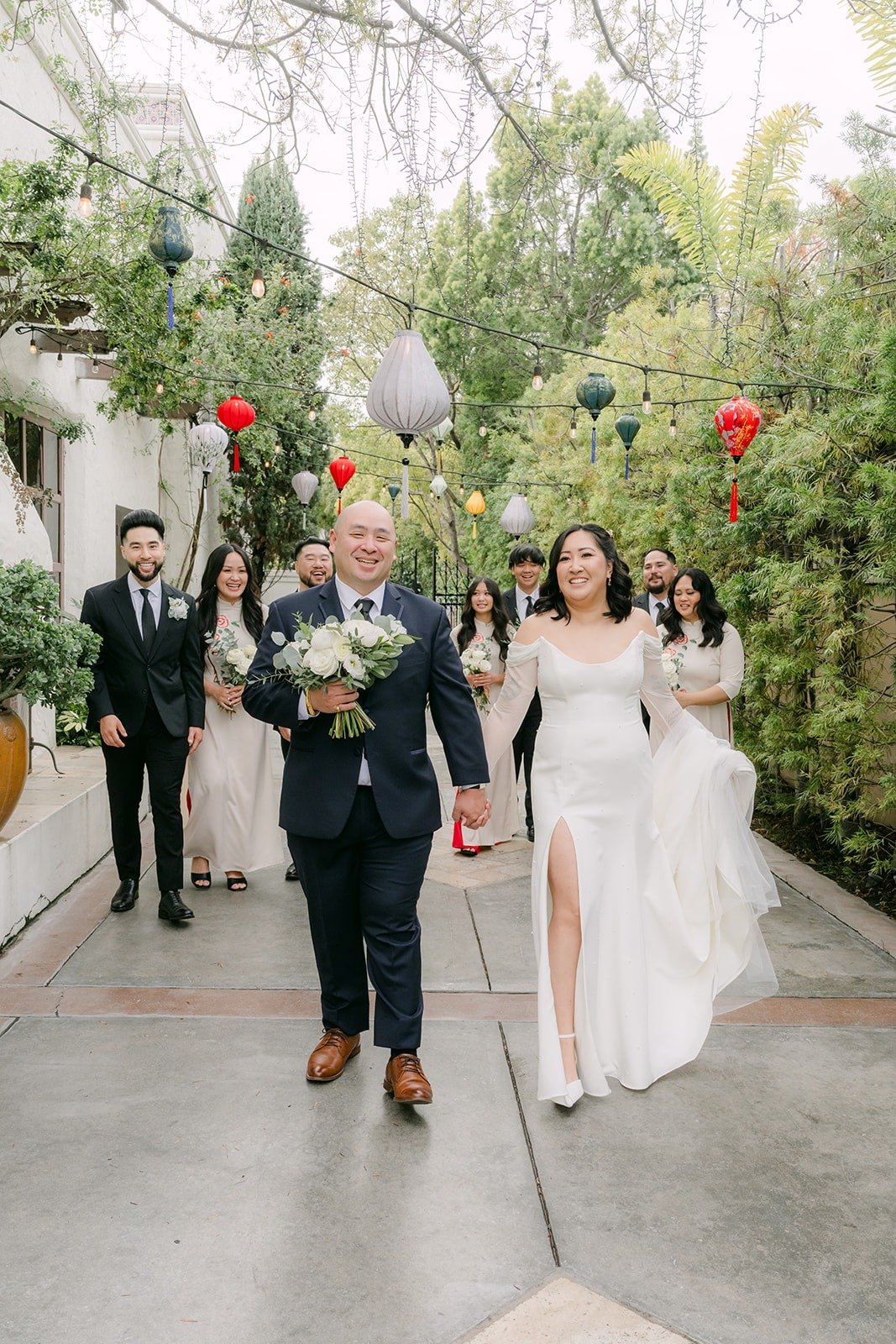 Vivian and Yao walking with their wedding party