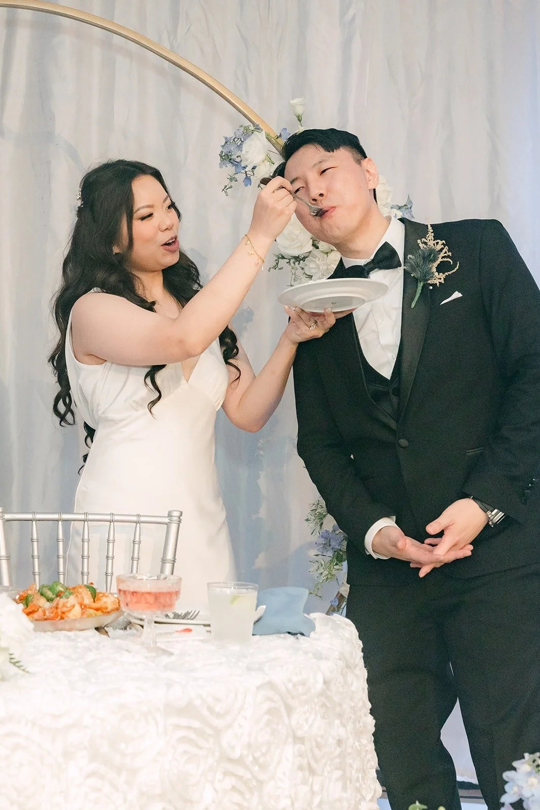 Emily feeding James a bite of cake