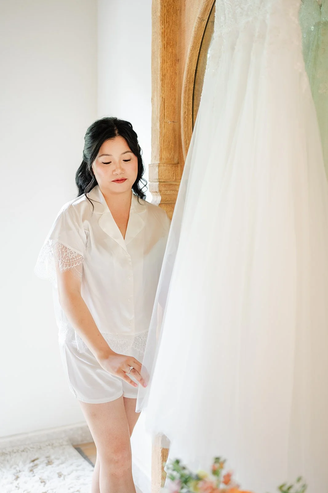 Constance in her robe standing beside her wedding gown