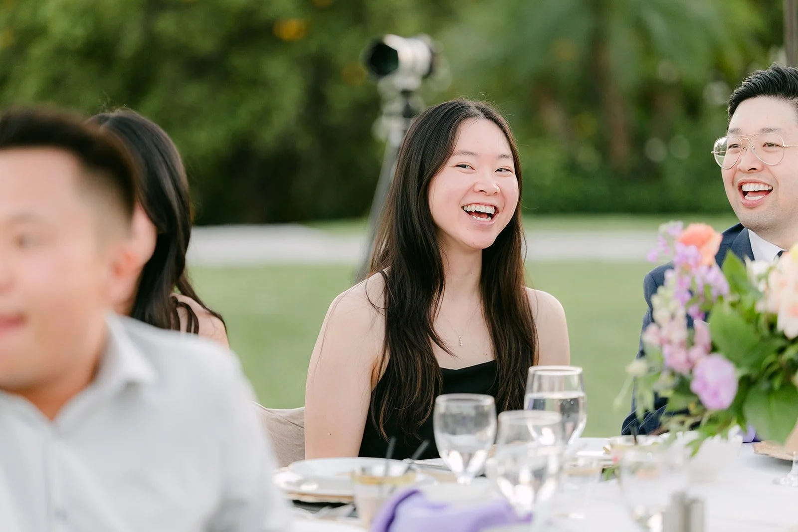 Friends laughing at their table.