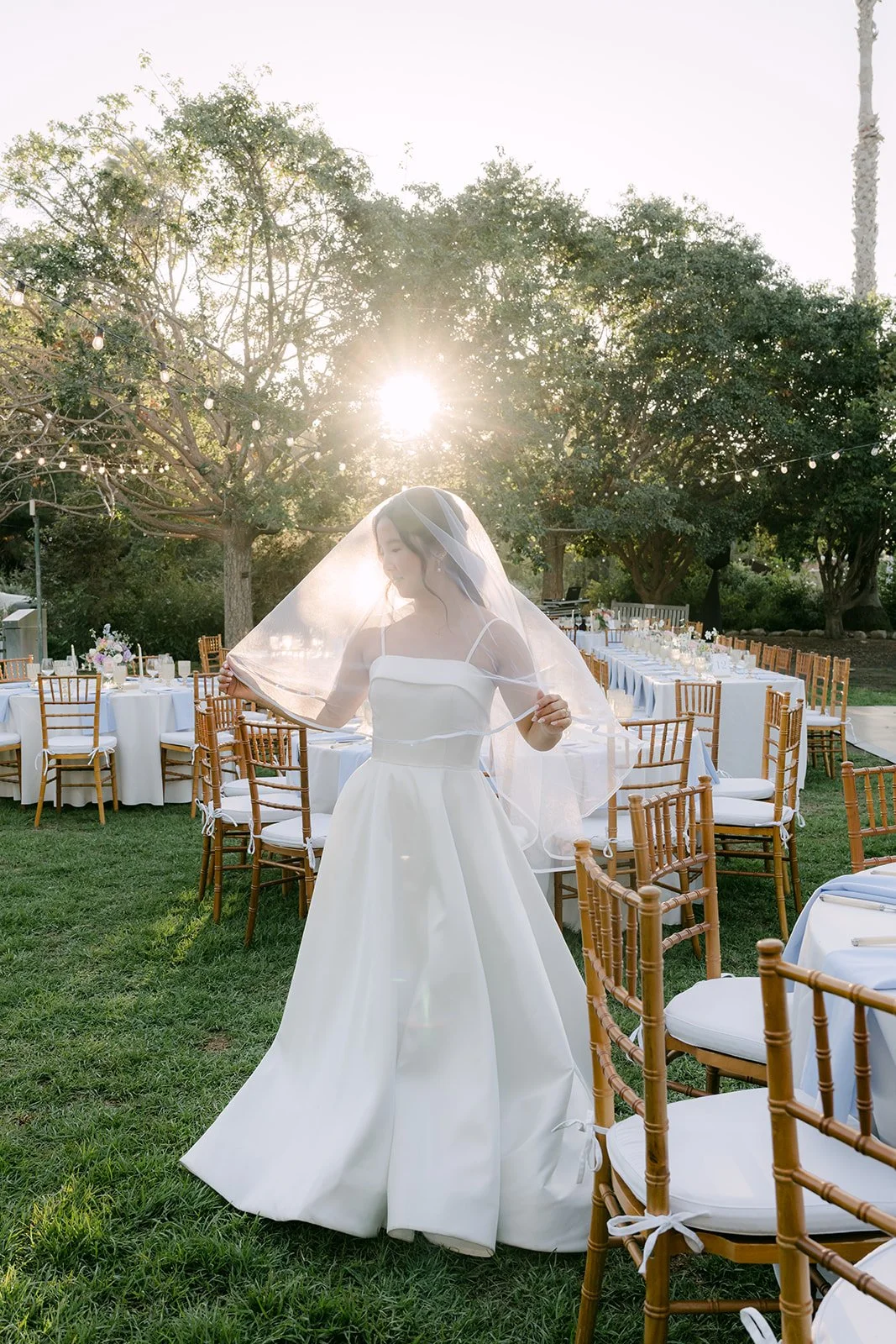 Saya walking through the reception tables at golden hour