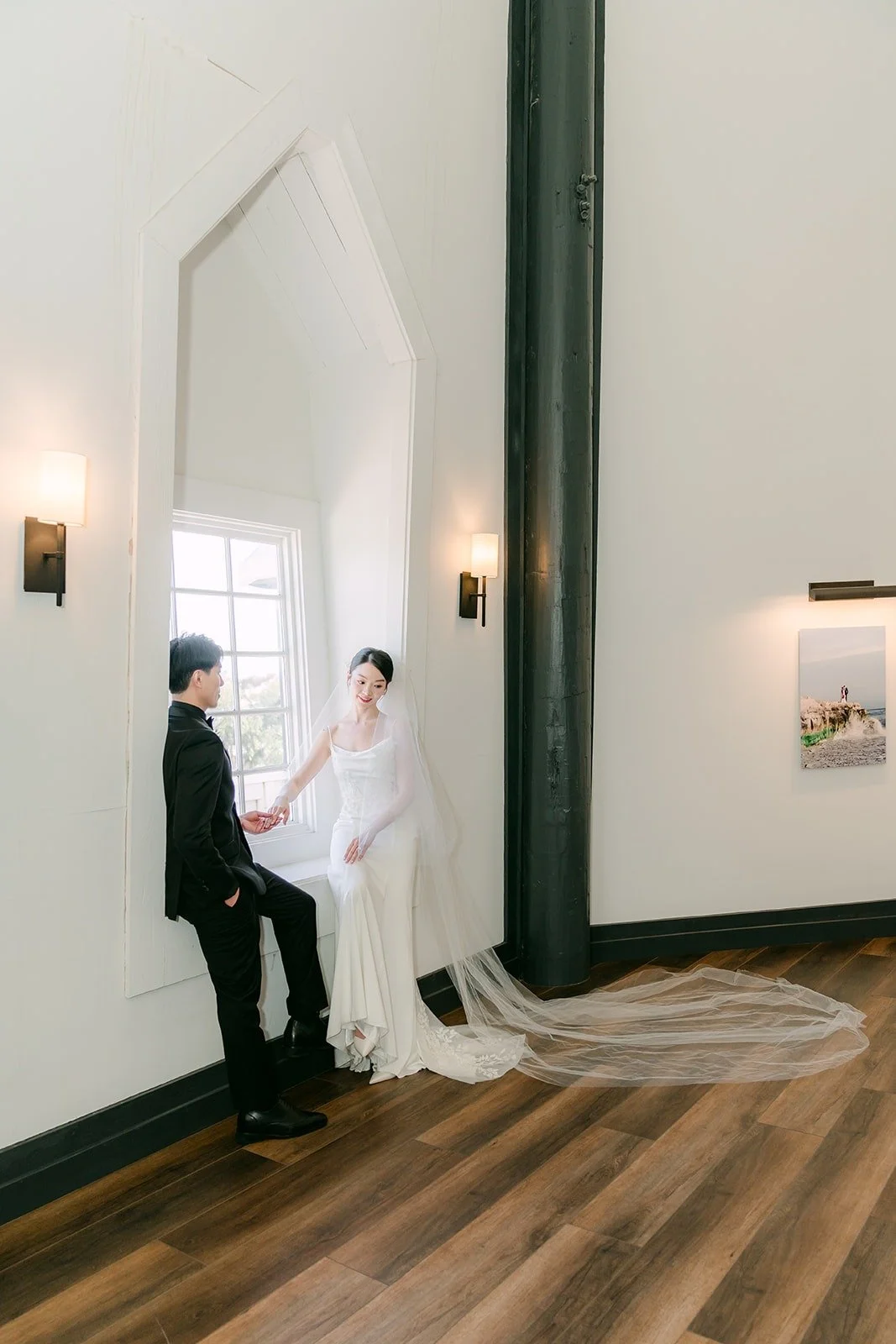 Fong holding Tin's hand by the arched window