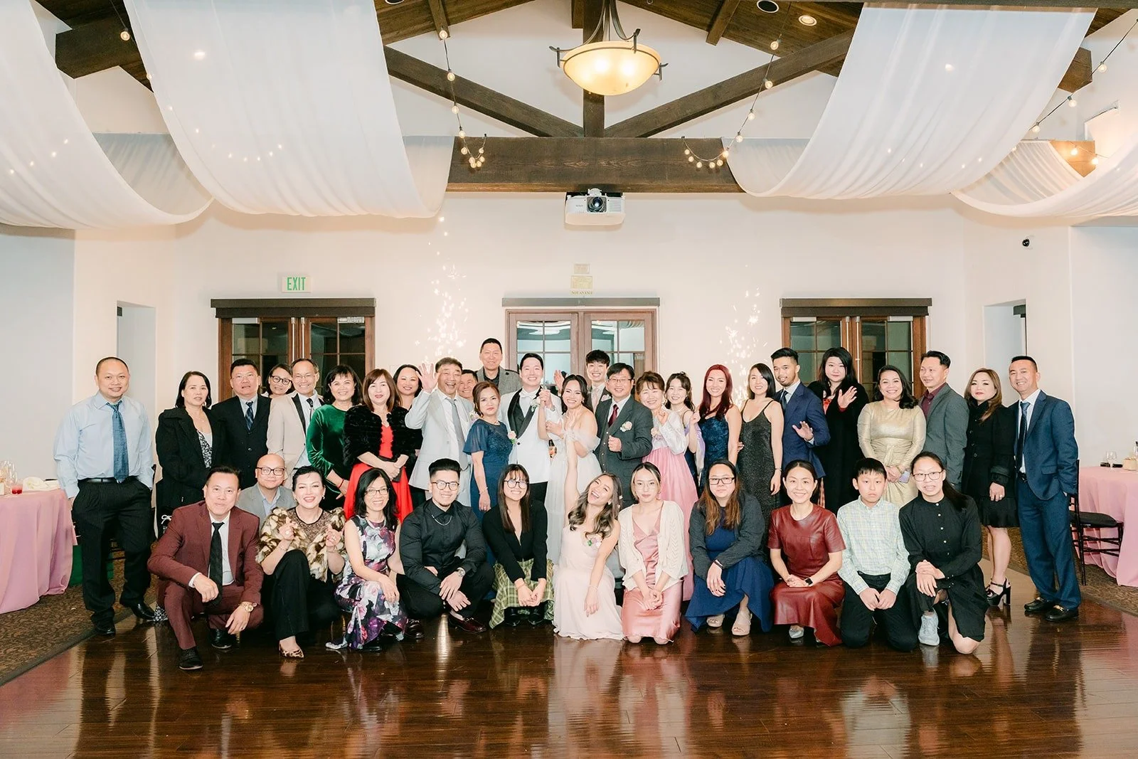 All the guests together for a group photo in the ballroom