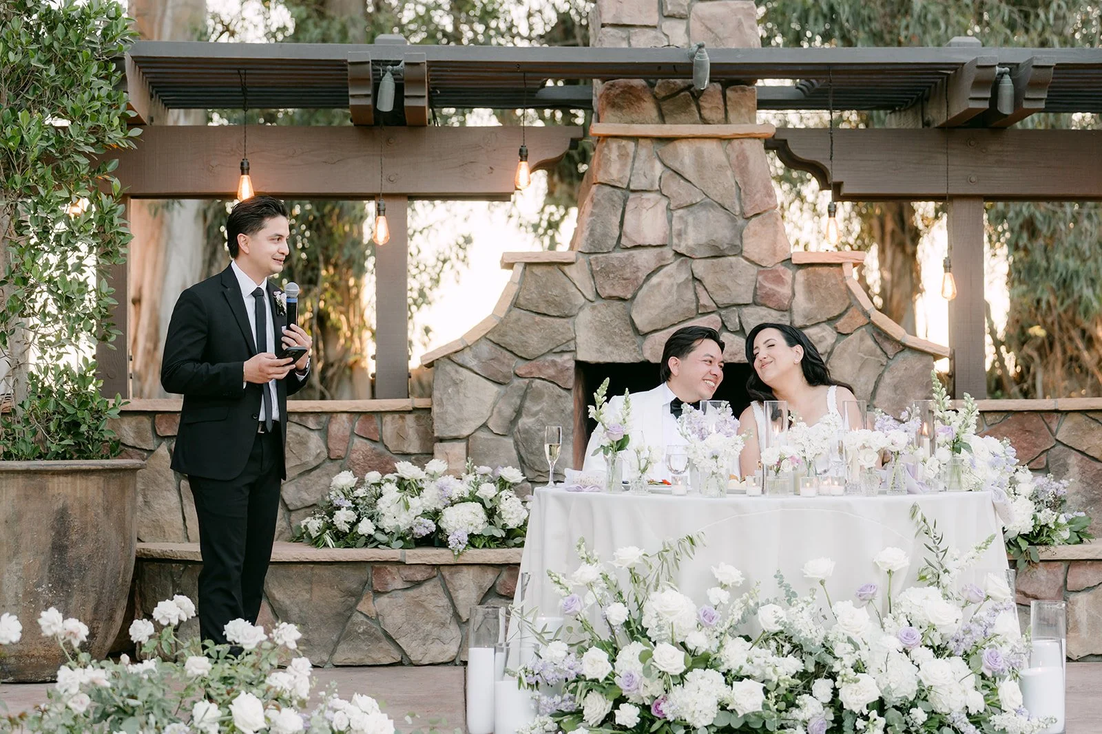 Best man giving a speech by the stone fireplace