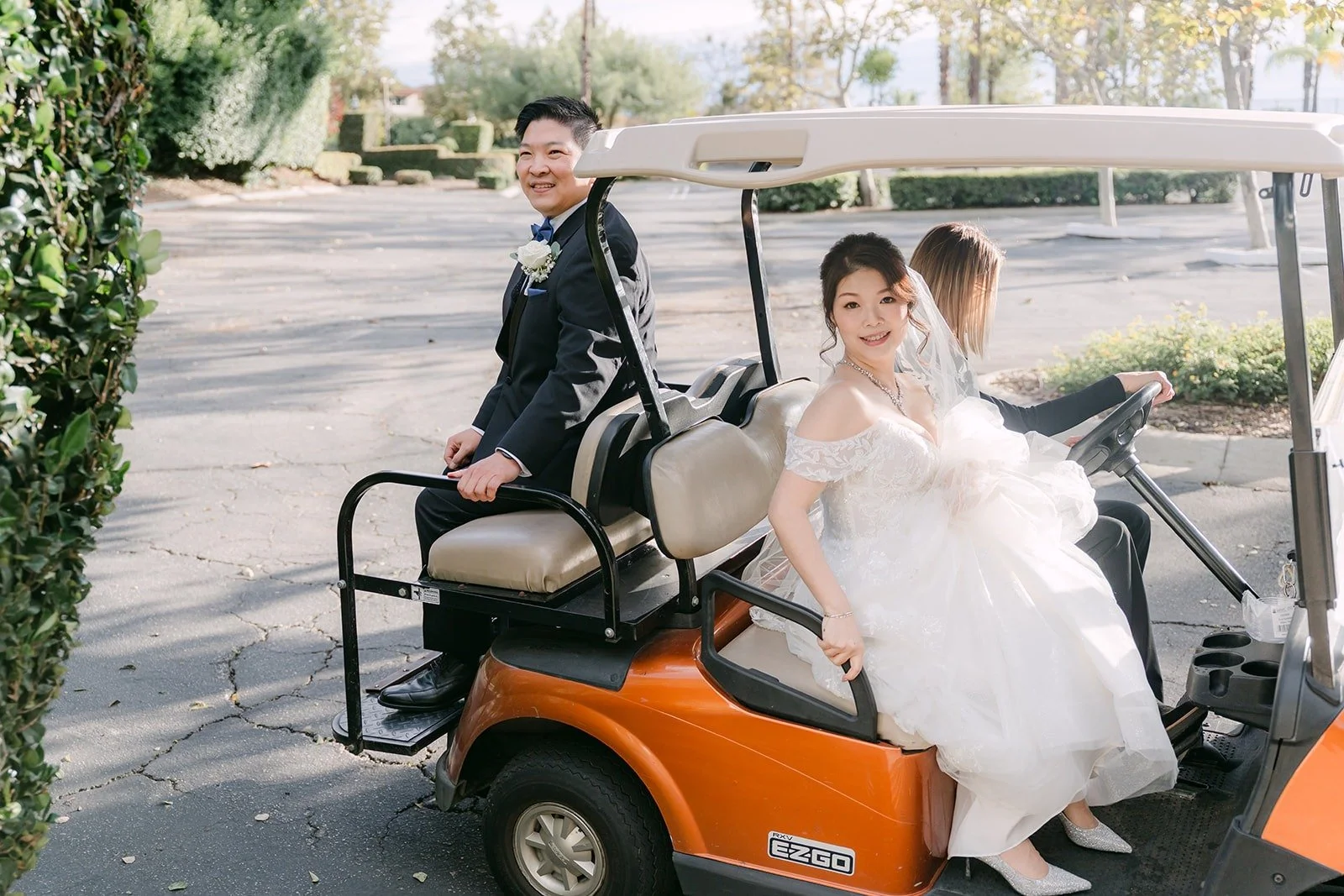 Sochi and Jay riding a golf cart between photo locations at Sierra La Verne