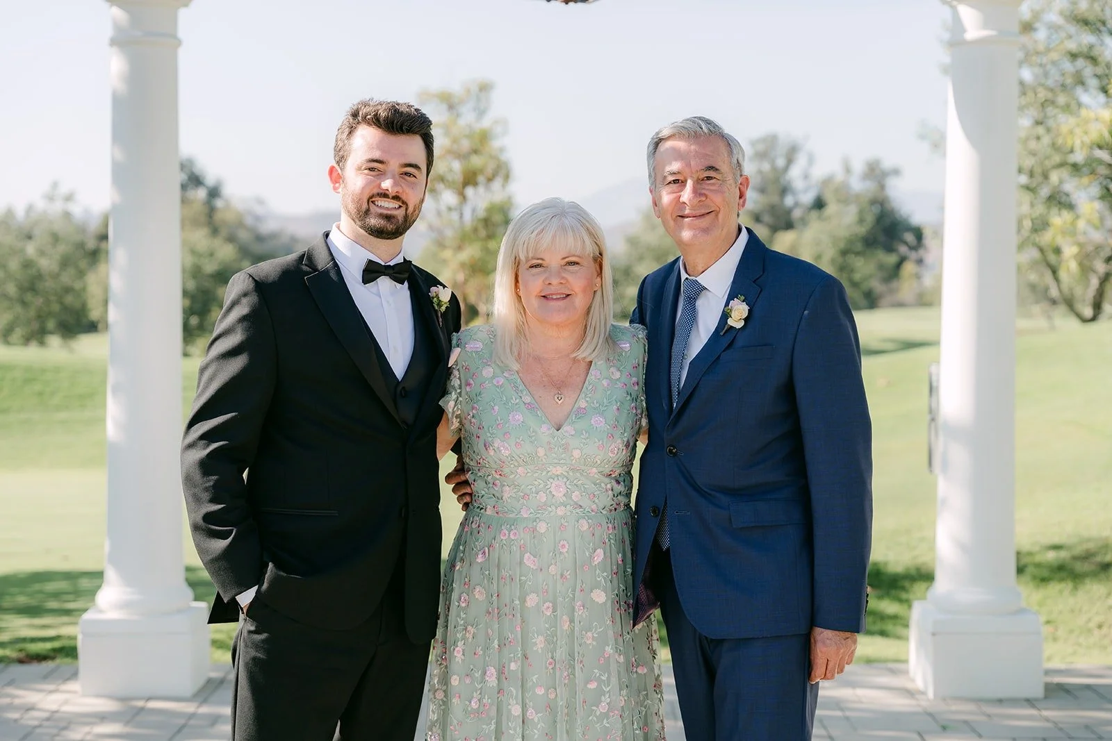 Kevin with two family members on the ceremony lawn