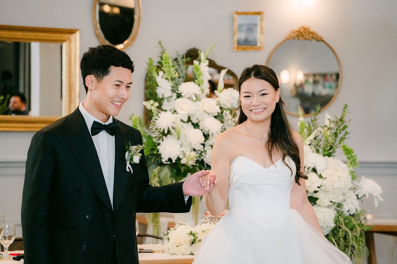 Jadee and Richard by the sweetheart table florals