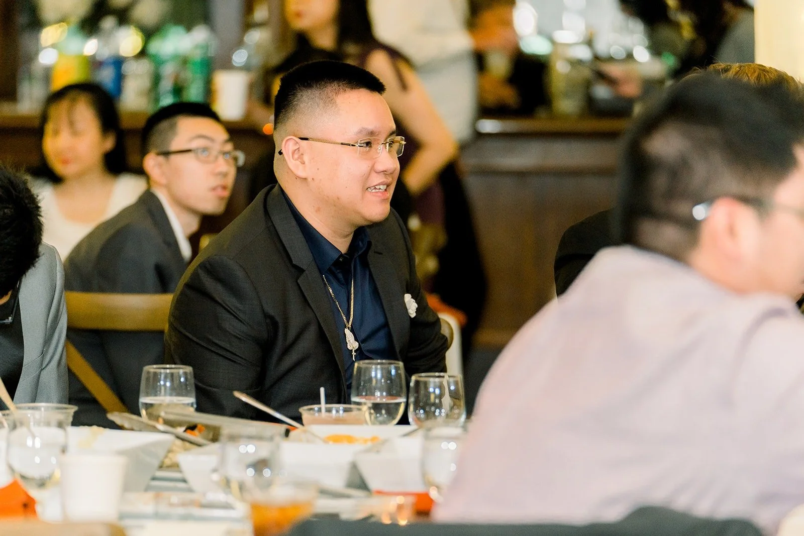 Guests listening at their table, photographed by One and Only Production