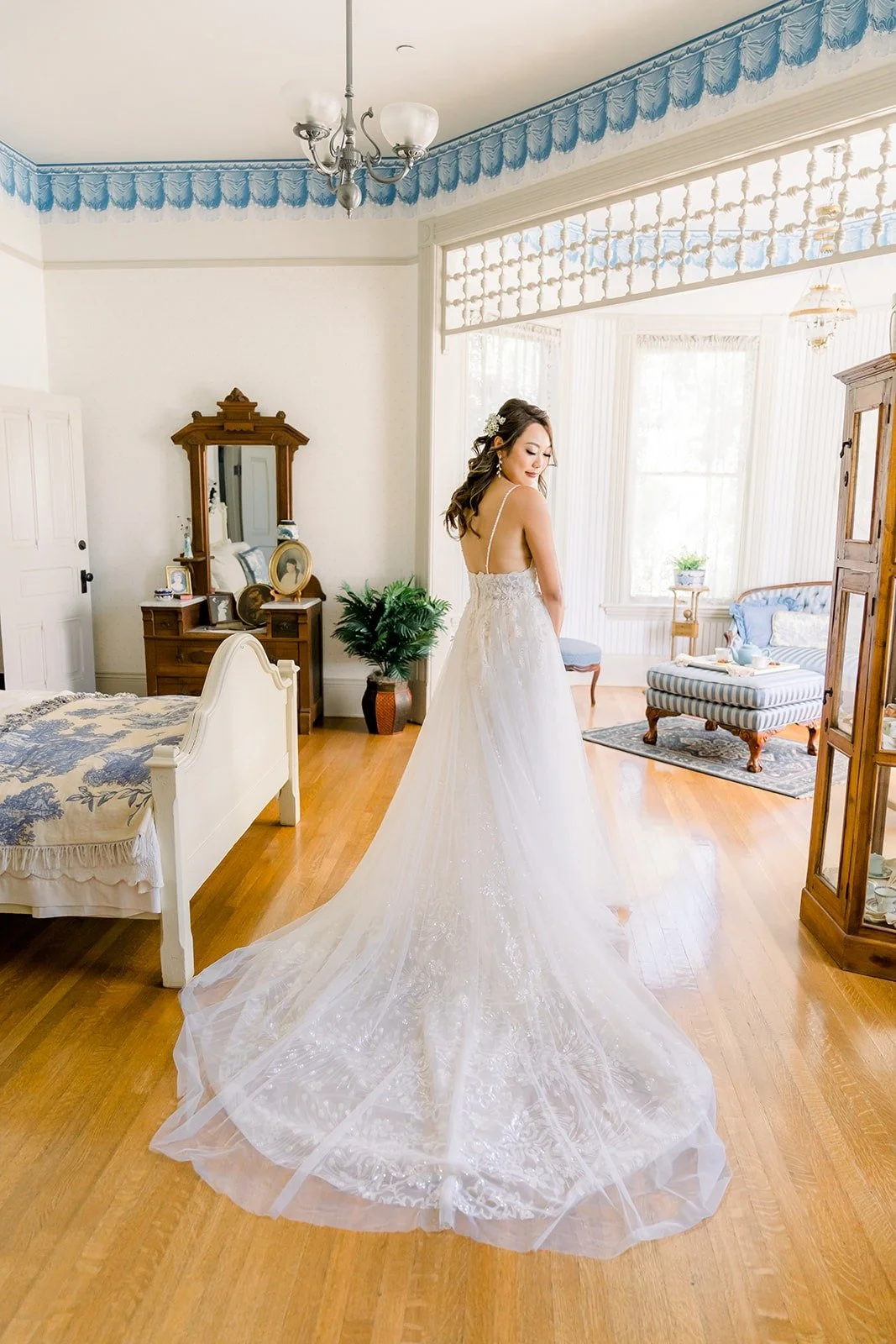 Ariel's long train spread across the wooden floor of the bridal room
