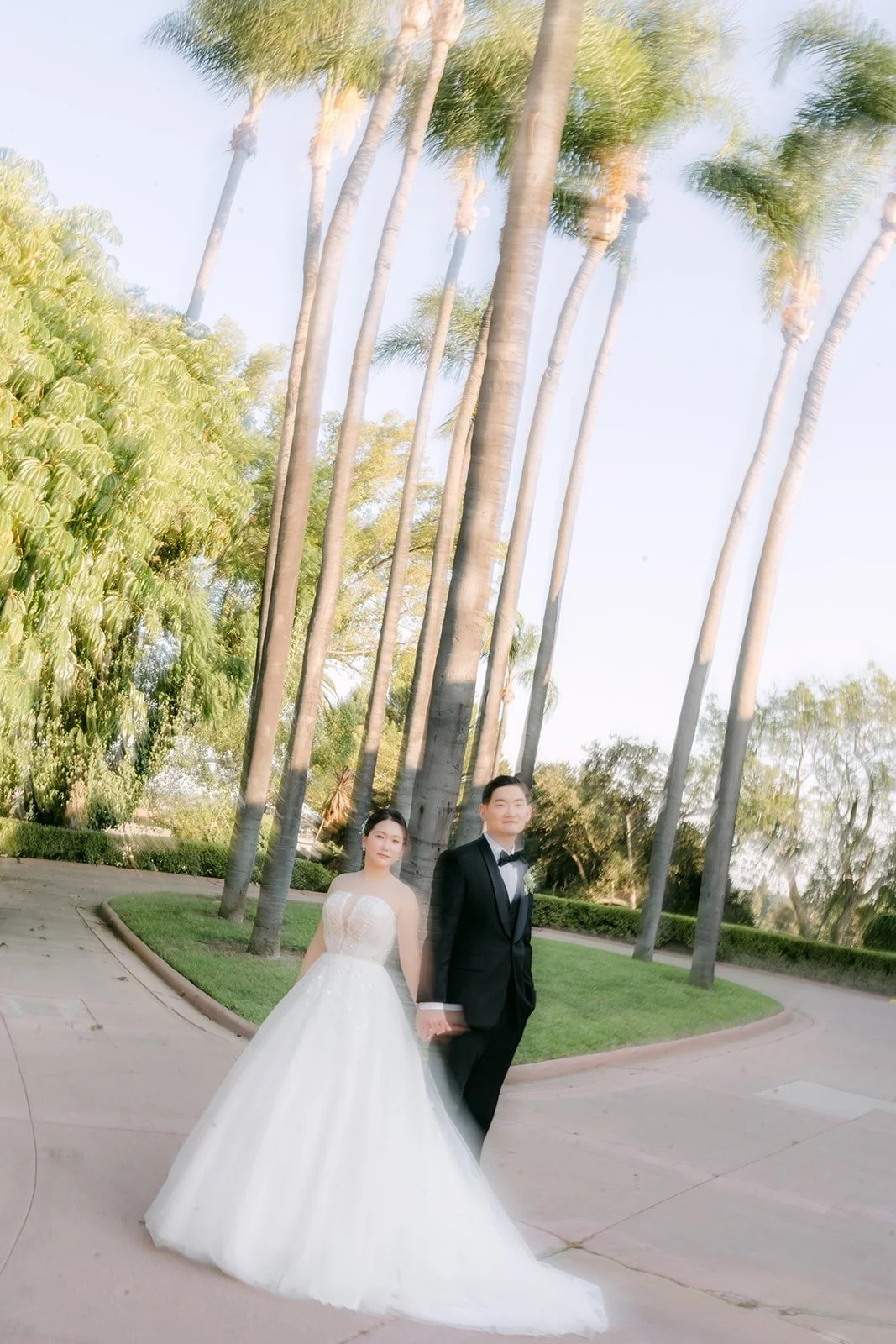 Amy and Sam walking under the palm trees