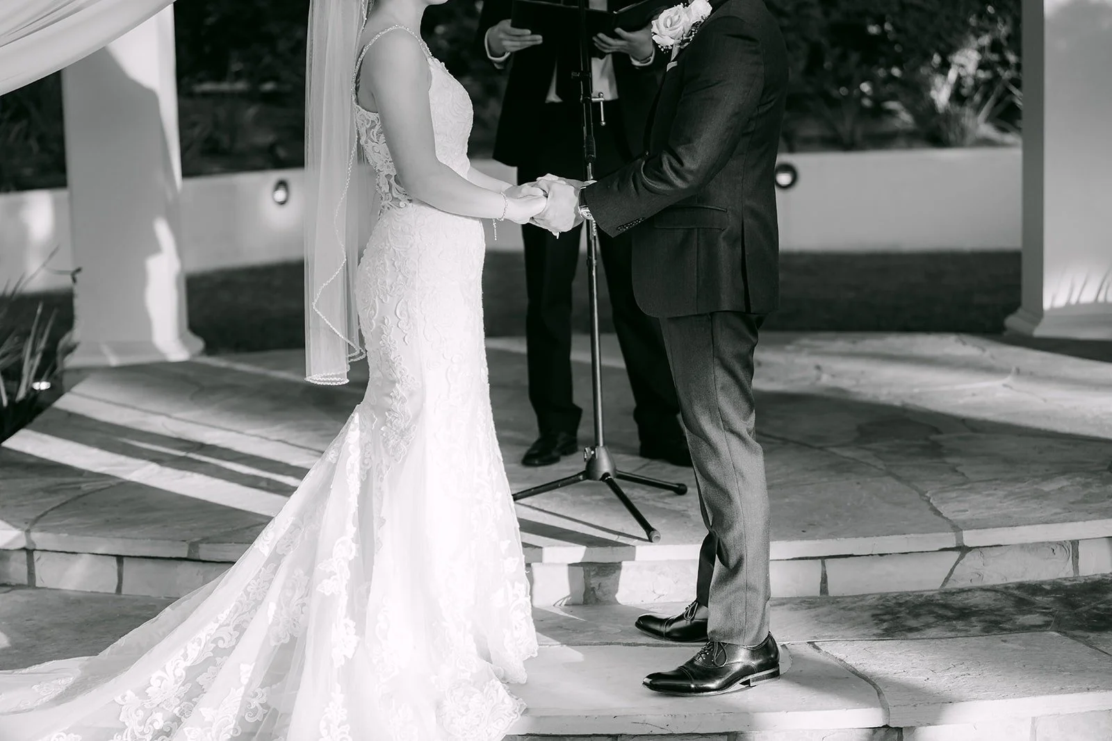 Xuemin and Alex holding hands under the gazebo in black and white