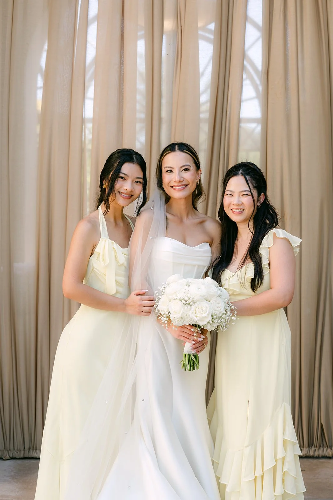 Kieu with two of her bridesmaids in butter yellow, photographed by One and Only Production
