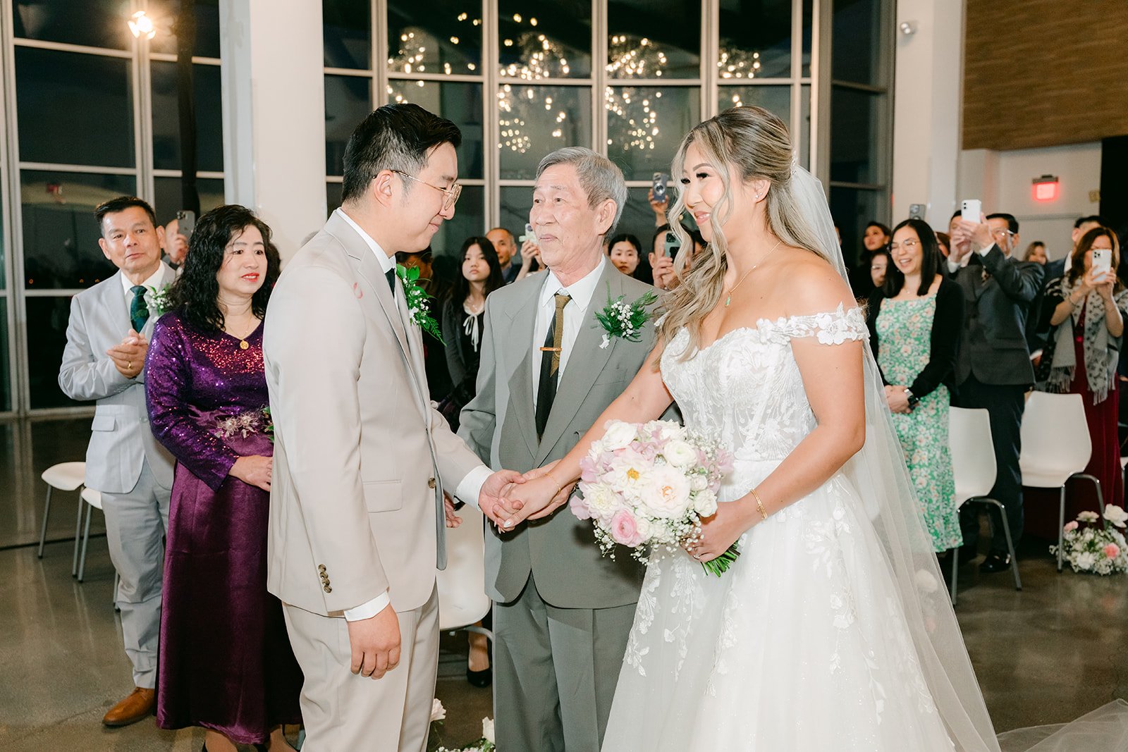 Father of the bride giving Raine's hand to Ricky at the altar