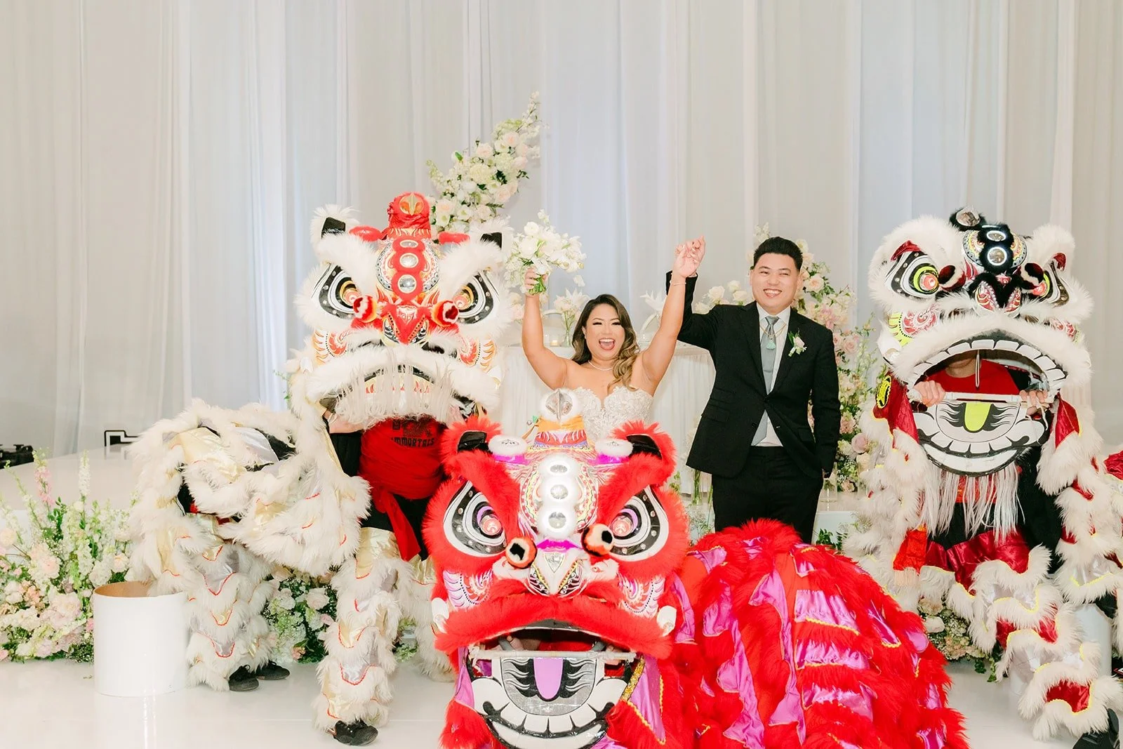 Candice and Vincent walking in with the Immortals lion dancers