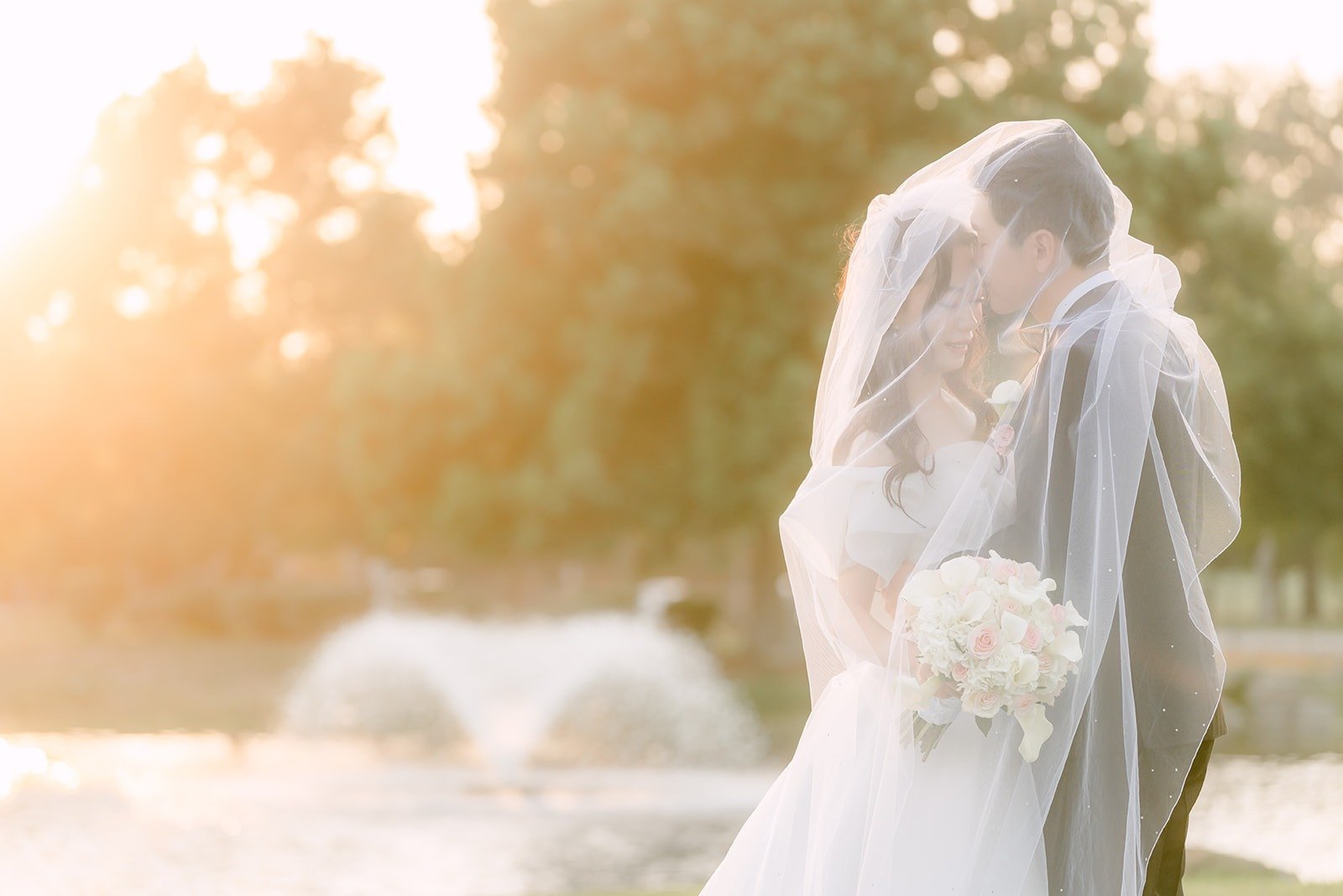 Jeannie and Eunsang under her veil in front of the fountain