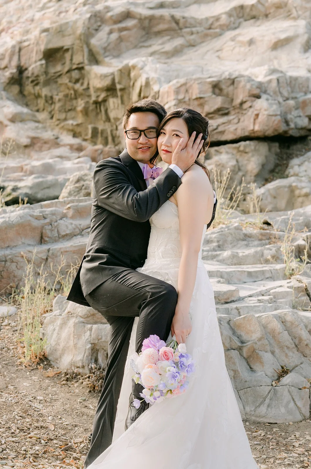 Patrick embracing Mary on the rocks