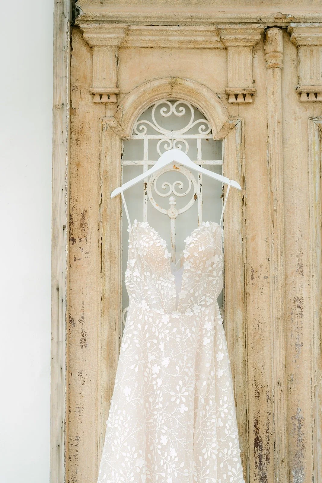 Joanna's sparkling gown hanging on a carved wooden door
