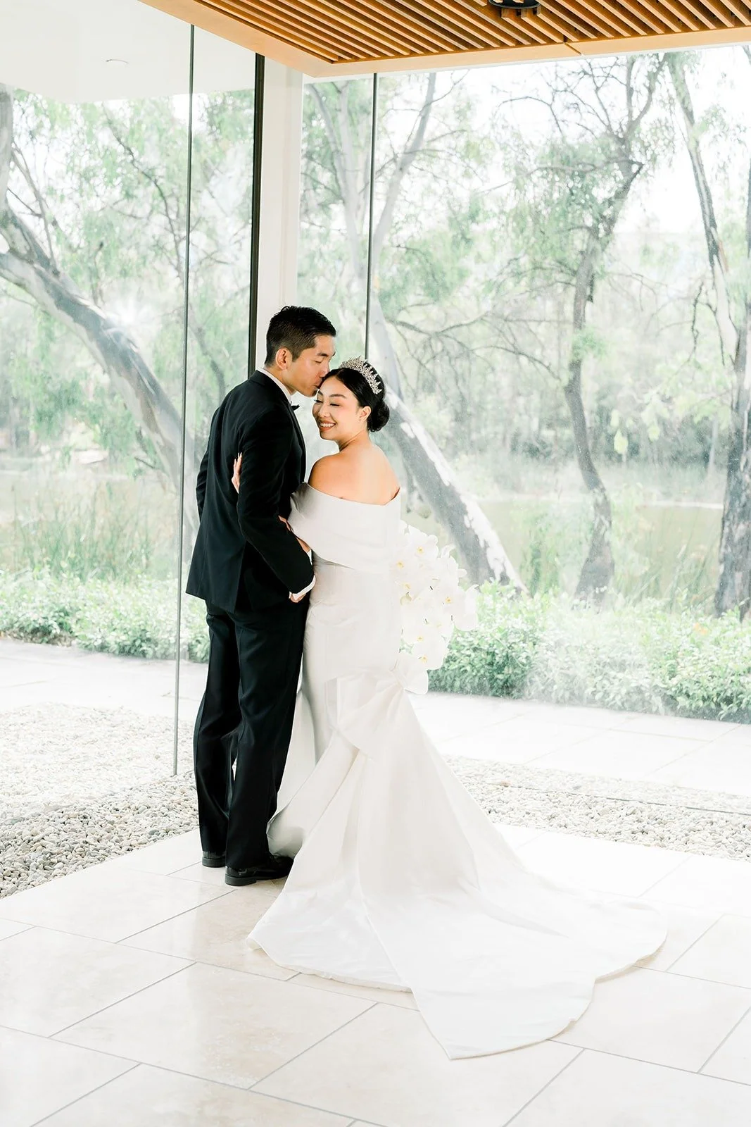 Steven kisses Jacinda under the wood slat ceiling