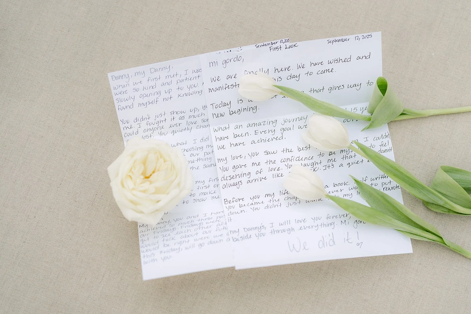A handwritten letter styled with a white rose and tulips
