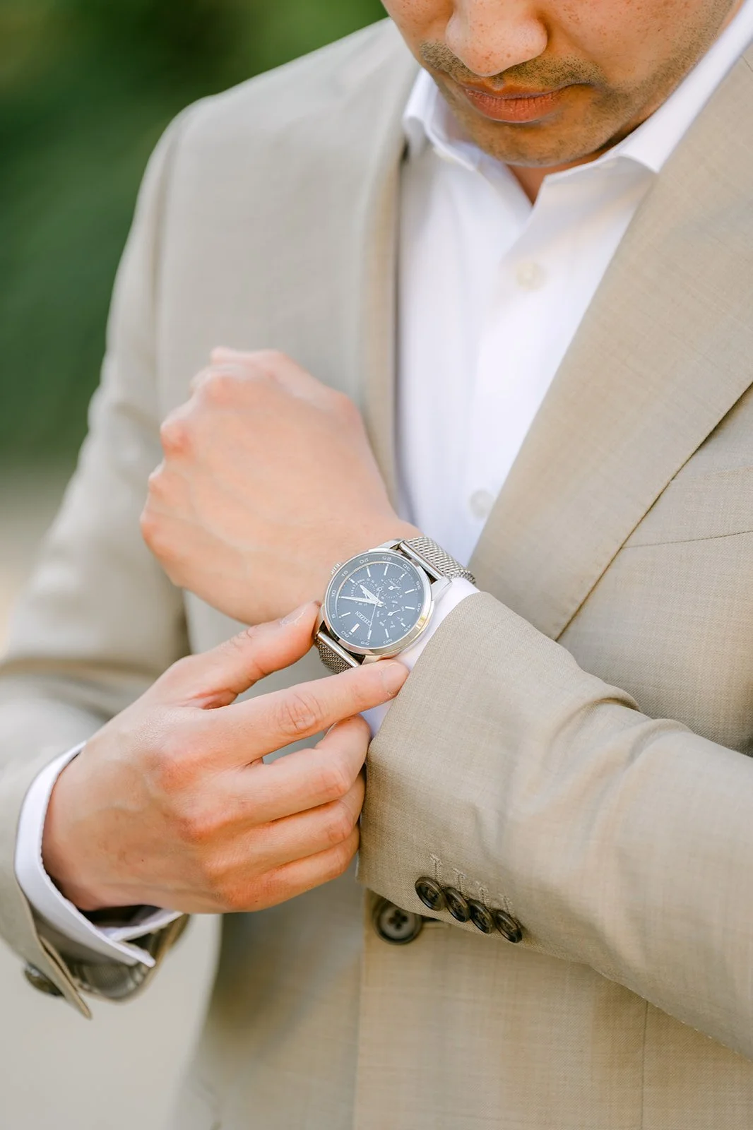 Detail of Vincent adjusting his watch and cuff.
