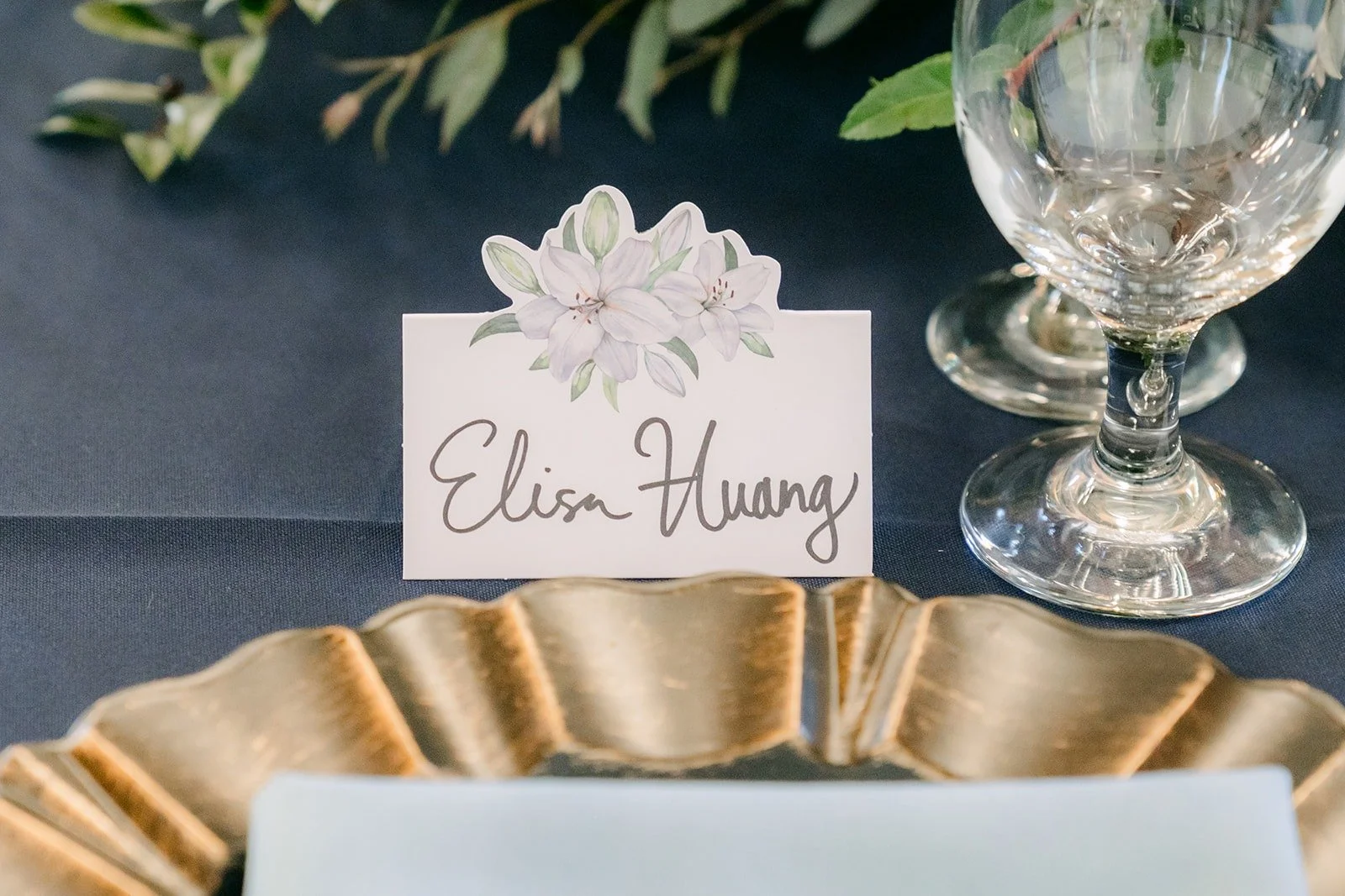 A place card for Elisa on a gold charger
