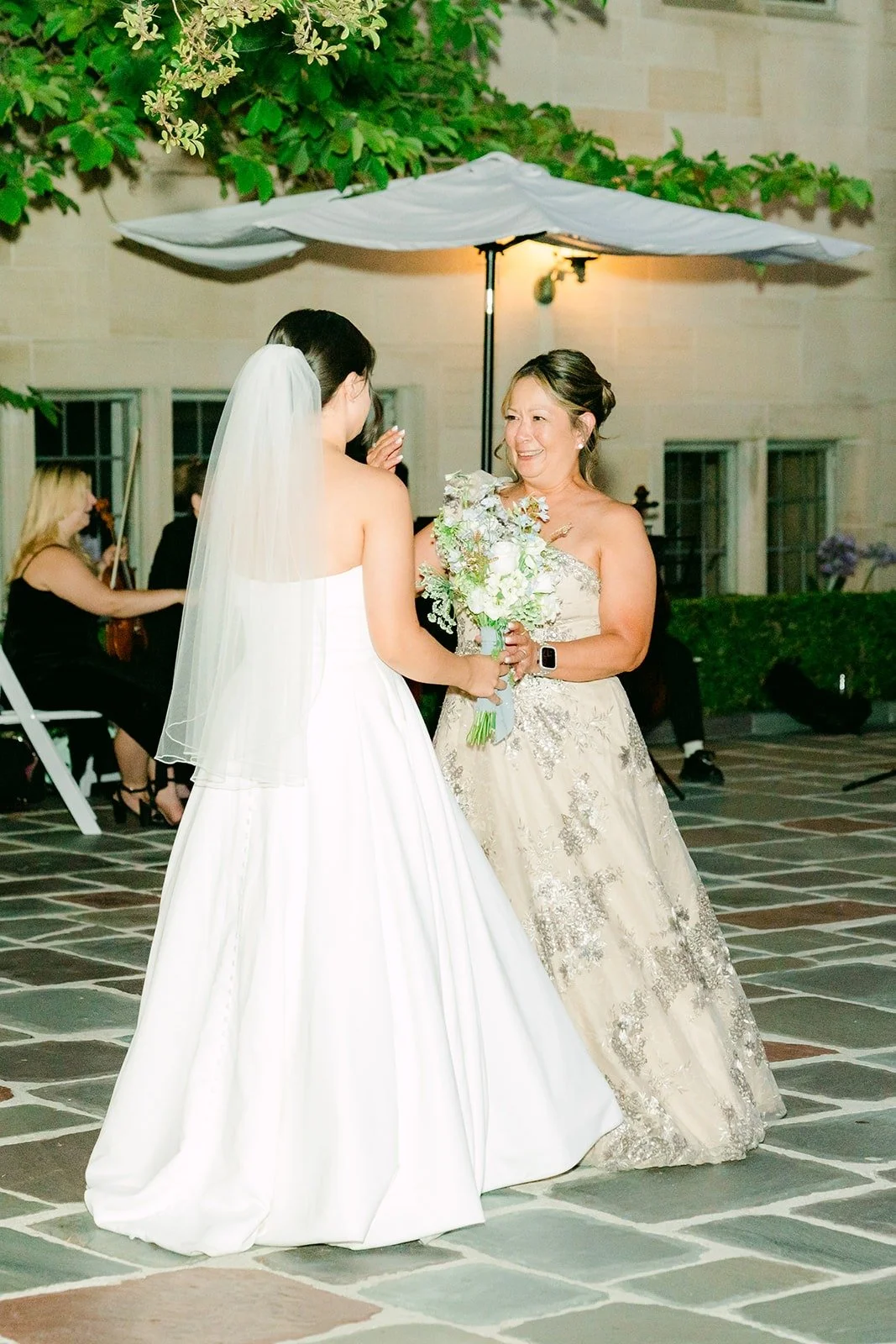 Brianna laughing with a guest before the bouquet toss
