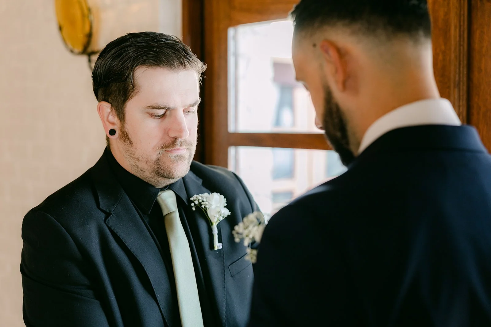 Danny and a friend in black suits before the ceremony