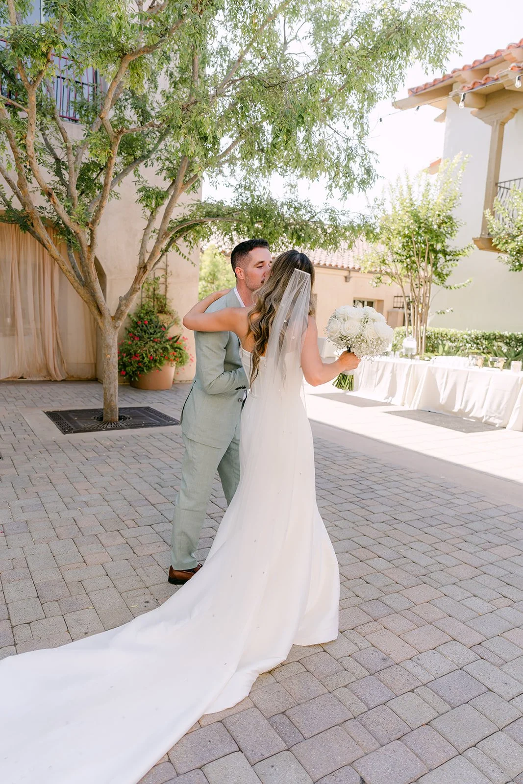 Newlyweds walking back up the aisle with her train behind her