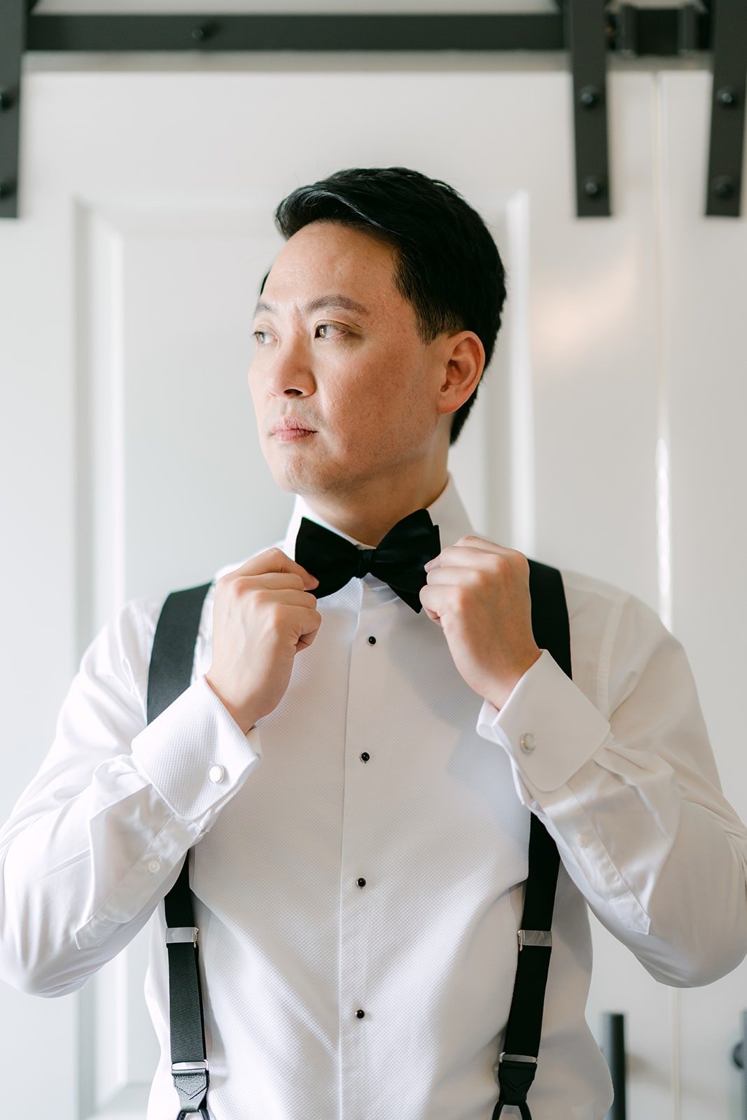 William straightening his black bow tie