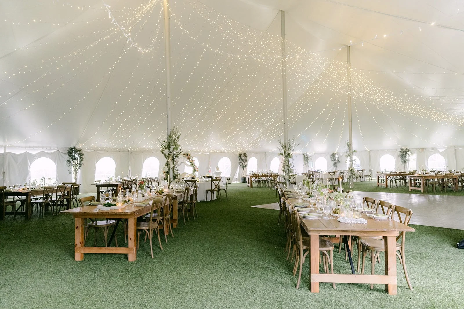 Inside the Open Air Pavilion with long farm tables and string lights